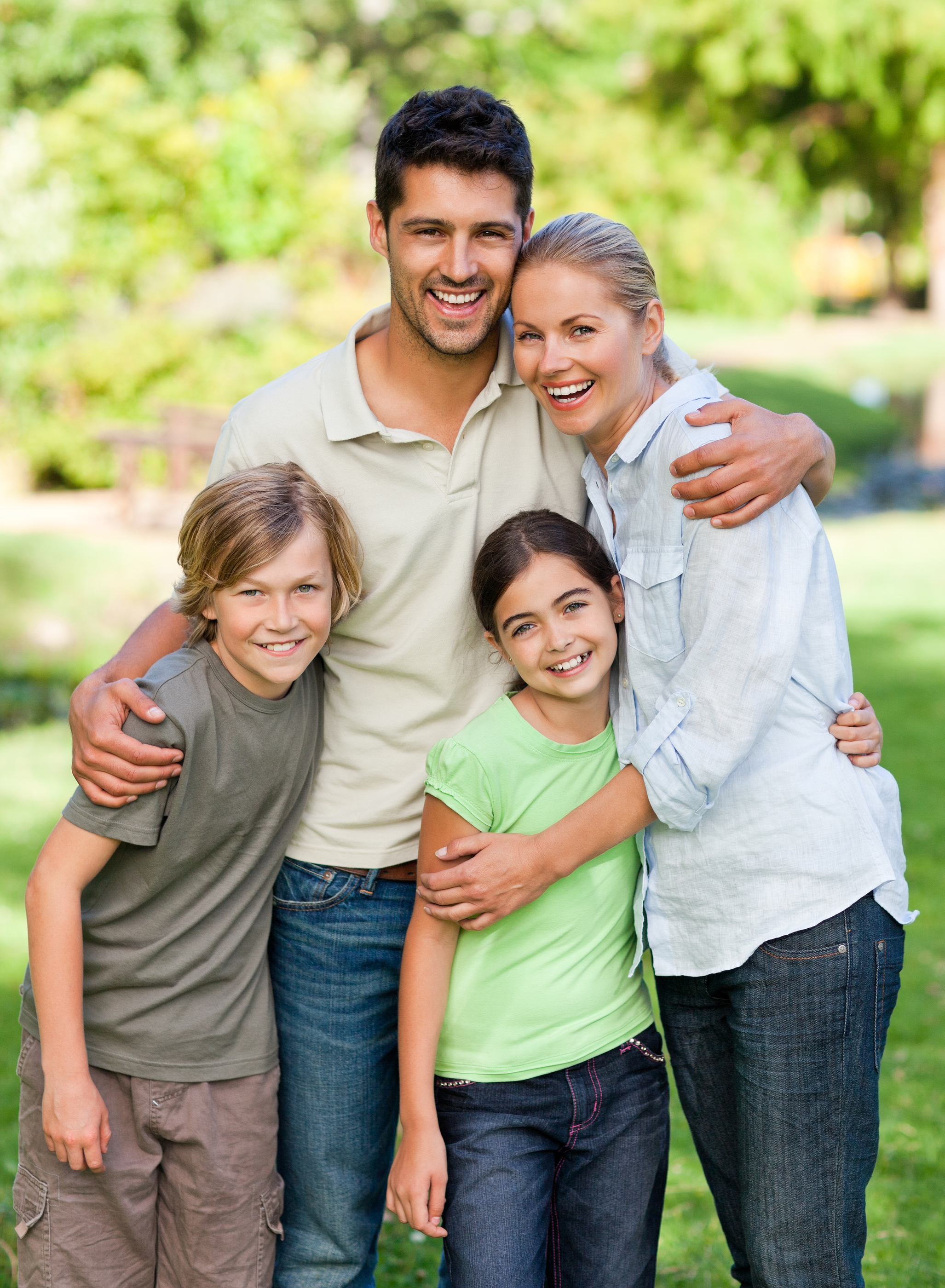 family posing outdoors in park, North York, ON family dentistry
